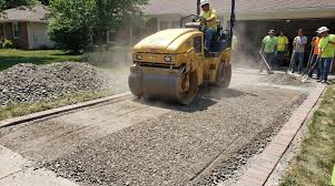 We excavate the compromised clay, lay down our crushed rock base, and utilize heavy vibratory plate compactors to lock the aggregate into a dense, unyielding foundation before tying the steel rebar grid.